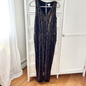 Black and gold jumpsuit. Ties at waist. 100% rayon